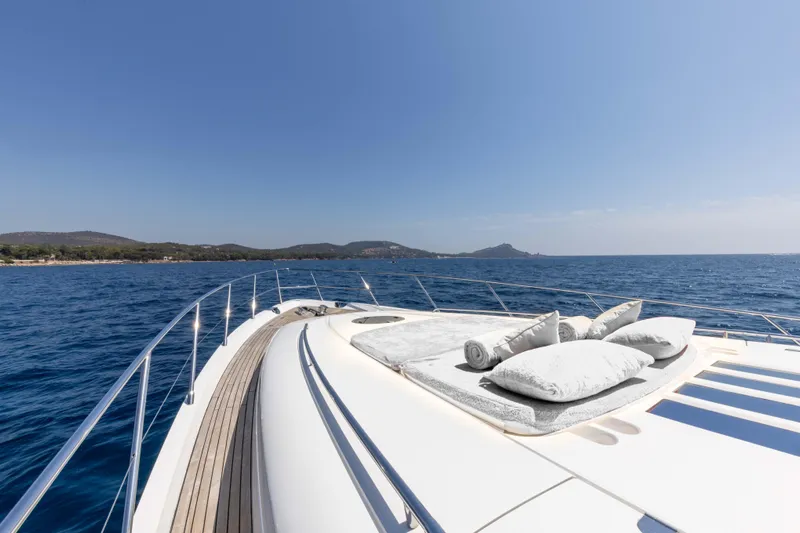 P'tite Bouille Yacht Photos Pics Luxurious 2008 Princess V70 yacht deck with cushions, cruising on a sunny day.