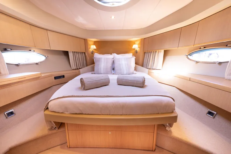 P'tite Bouille Yacht Photos Pics Luxurious cabin interior of 2008 Princess V70 yacht with elegant bedding and ambient lighting.