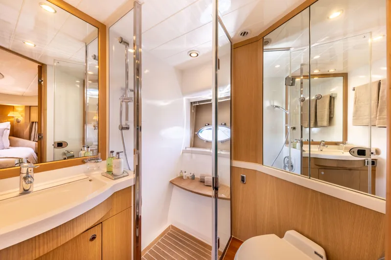P'tite Bouille Yacht Photos Pics Luxurious bathroom interior of 2008 Princess V70 yacht with modern fixtures and wooden accents.