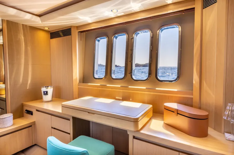 P'tite Bouille Yacht Photos Pics Luxurious interior of 2008 Princess V70 yacht with ocean view through large windows.