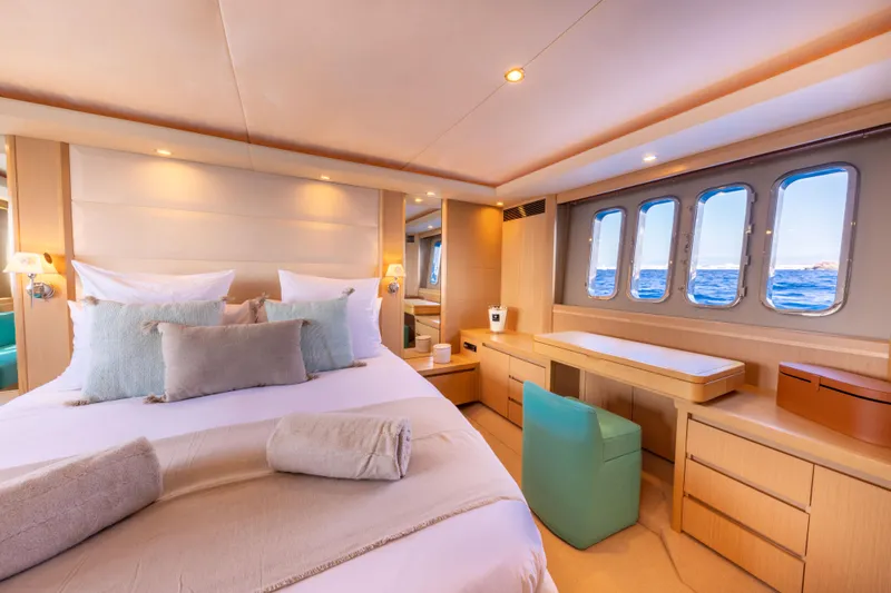 P'tite Bouille Yacht Photos Pics Luxurious bedroom interior of 2008 Princess V70 yacht with ocean view windows.