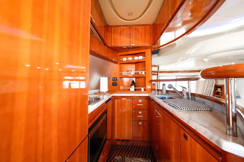 Finesse Yacht Photos Pics Luxurious wooden interior of 2007 Azimut 68E yacht kitchen with modern amenities.