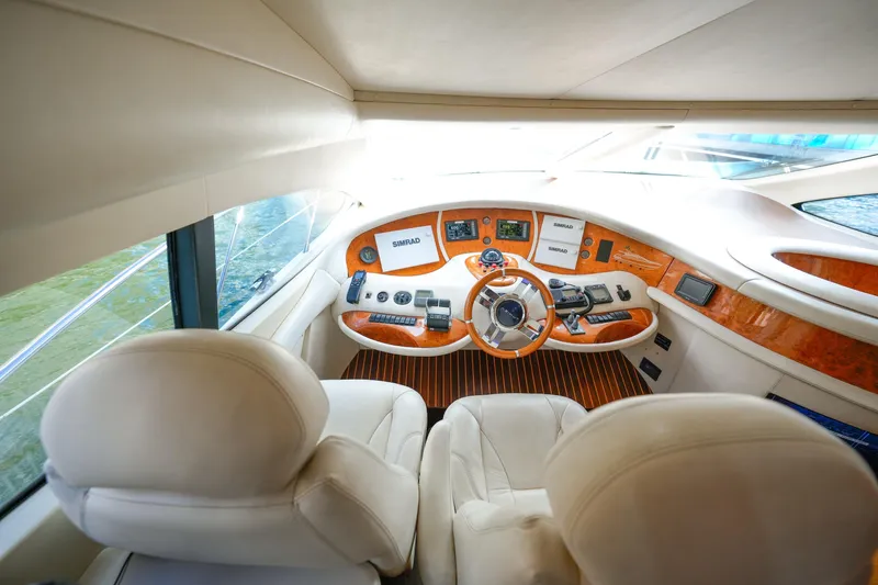 Finesse Yacht Photos Pics Luxurious helm of 2007 Azimut 68E yacht with leather seats and advanced navigation controls.