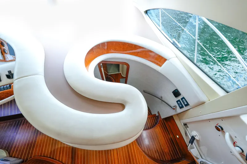 Finesse Yacht Photos Pics Luxurious interior of 2007 Azimut 68E yacht with elegant curved seating and wooden flooring.