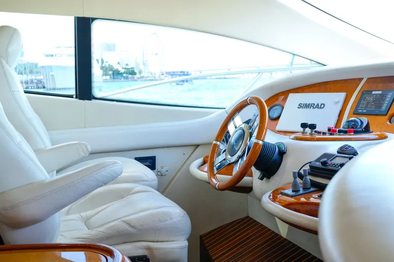 Finesse Yacht Photos Pics Luxurious 2007 Azimut 68E yacht helm with leather seating and advanced navigation controls.