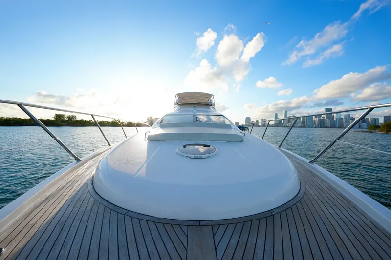 Finesse Yacht Photos Pics 2007 Azimut 68E yacht deck with city skyline and ocean view.