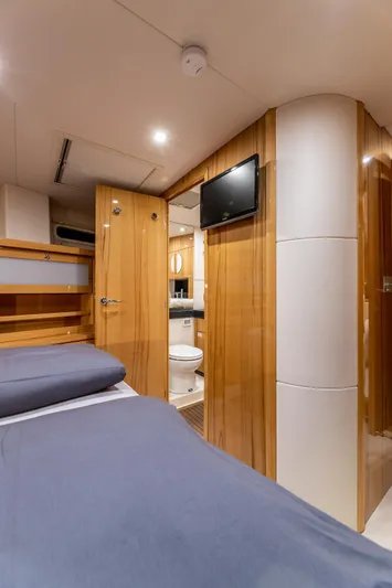  Yacht Photos Pics Interior of 2013 Hanse 630e yacht cabin with bed, TV, and bathroom.