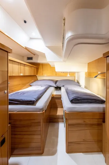 Yacht Photos Pics Luxurious interior of 2013 Hanse 630e yacht with twin beds and wooden finish.
