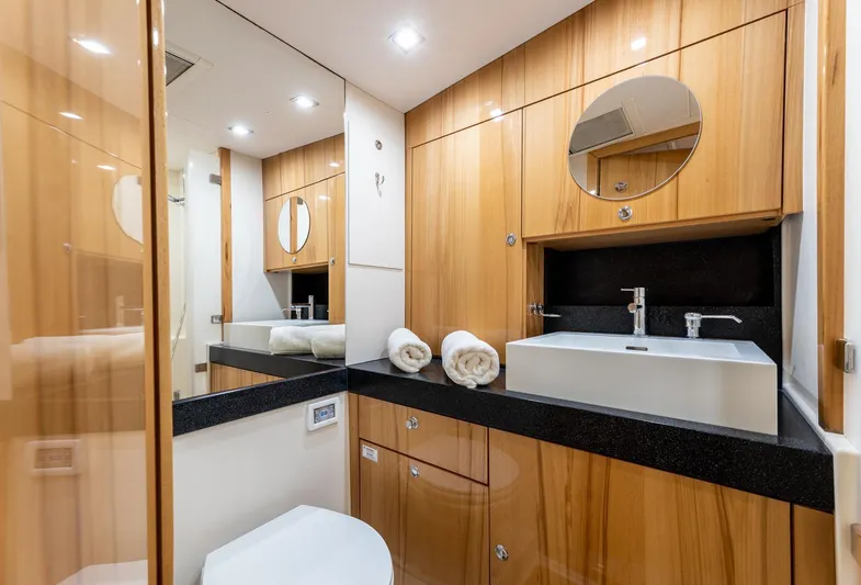  Yacht Photos Pics Luxurious bathroom in 2013 Hanse 630e yacht with modern fixtures and wooden cabinetry.