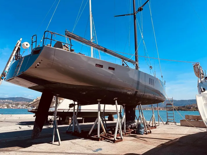  Yacht Photos Pics 2013 Hanse 630e yacht on dry dock, clear blue sky background.