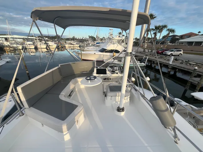 Isabelle Yacht Photos Pics 2016 Beneteau Swift Trawler 30 with spacious deck and seating area in harbor.