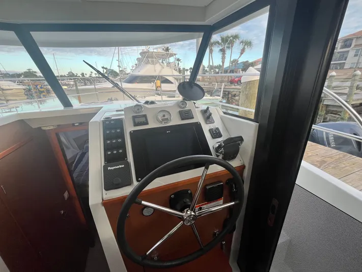 Isabelle Yacht Photos Pics Helm of 2016 Beneteau Swift Trawler 30 in marina.