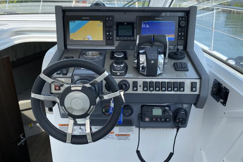  Yacht Photos Pics 2021 Cruisers Yachts 390 Express Coupe helm with advanced navigation and control systems.