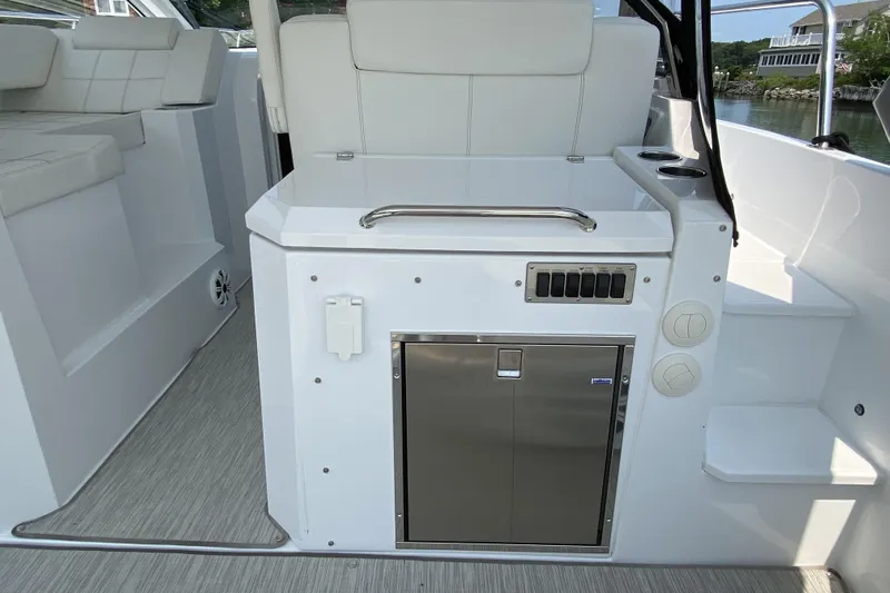 Yacht Photos Pics 2021 Cruisers Yachts 390 Express Coupe interior with sleek white seating and modern amenities.
