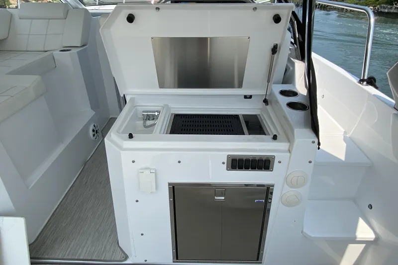 Yacht Photos Pics 2021 Cruisers Yachts 390 Express Coupe outdoor kitchen with grill and sink.