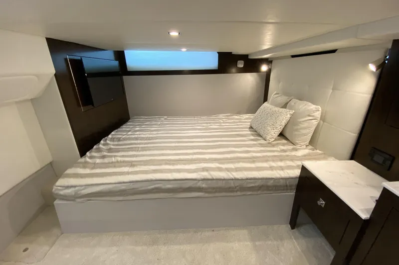  Yacht Photos Pics 2021 Cruisers Yachts 390 Express Coupe cabin with bed, TV, and modern decor.