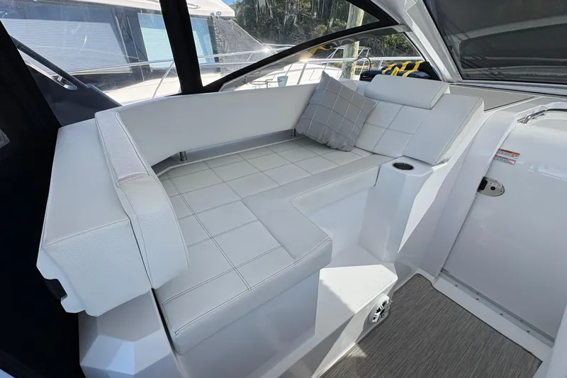  Yacht Photos Pics 2021 Cruisers Yachts 390 Express Coupe interior with white seating and cushion.