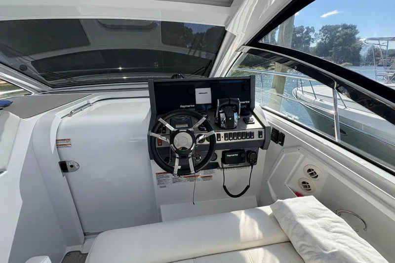  Yacht Photos Pics 2021 Cruisers Yachts 390 Express Coupe helm with modern navigation equipment and comfortable seating.