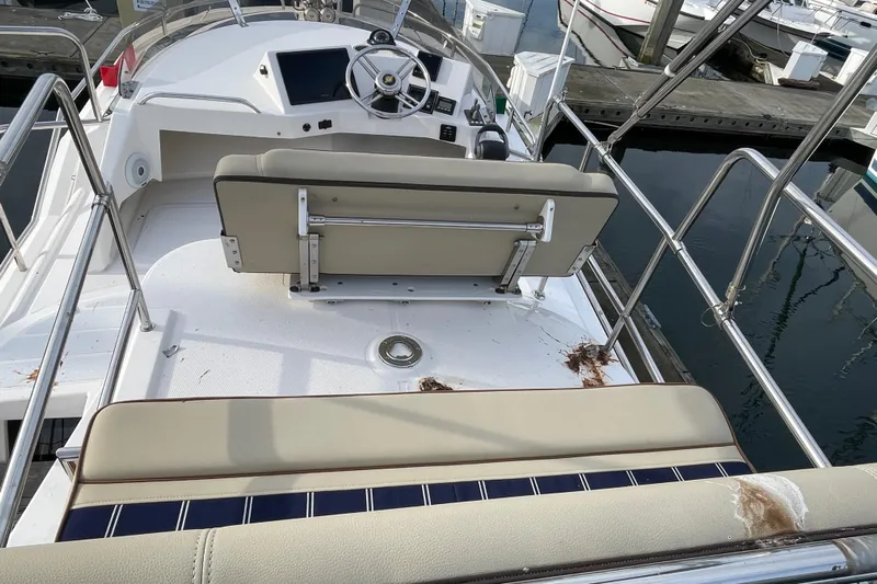 Poseidon&rsquo;s Lanai Yacht Photos Pics 2021 Ranger Tugs R-29 CB boat helm with seating, docked at marina.