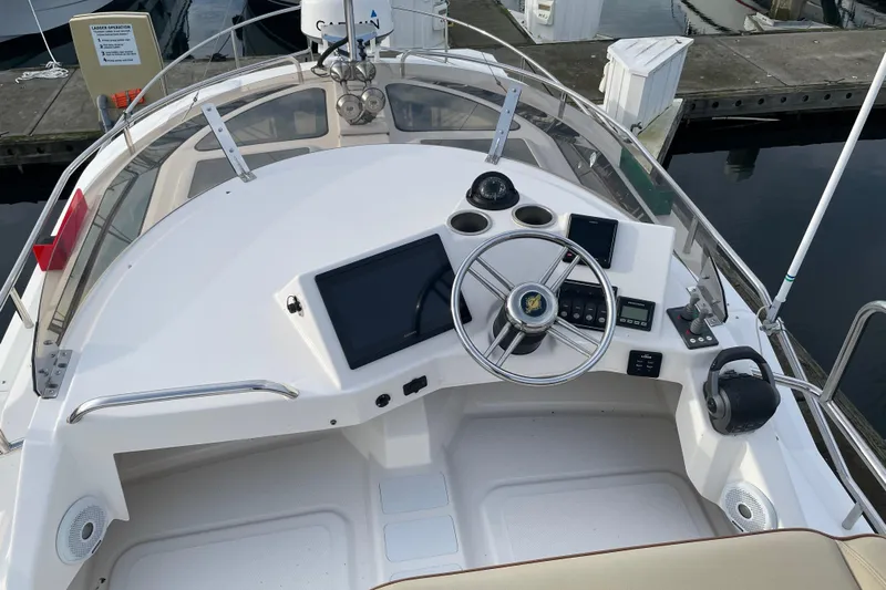 Poseidon&rsquo;s Lanai Yacht Photos Pics 2021 Ranger Tugs R-29 CB helm with modern controls and navigation equipment.