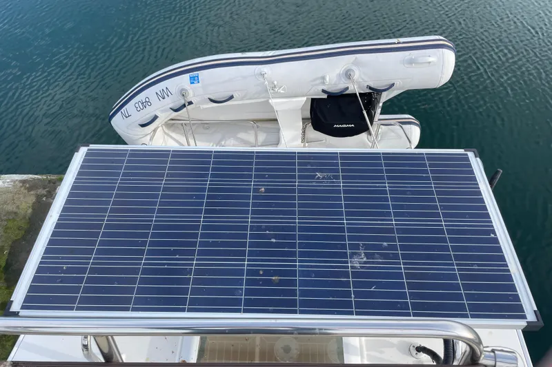 Poseidon&rsquo;s Lanai Yacht Photos Pics Solar panel on 2021 Ranger Tugs R-29 CB boat with inflatable dinghy in water.