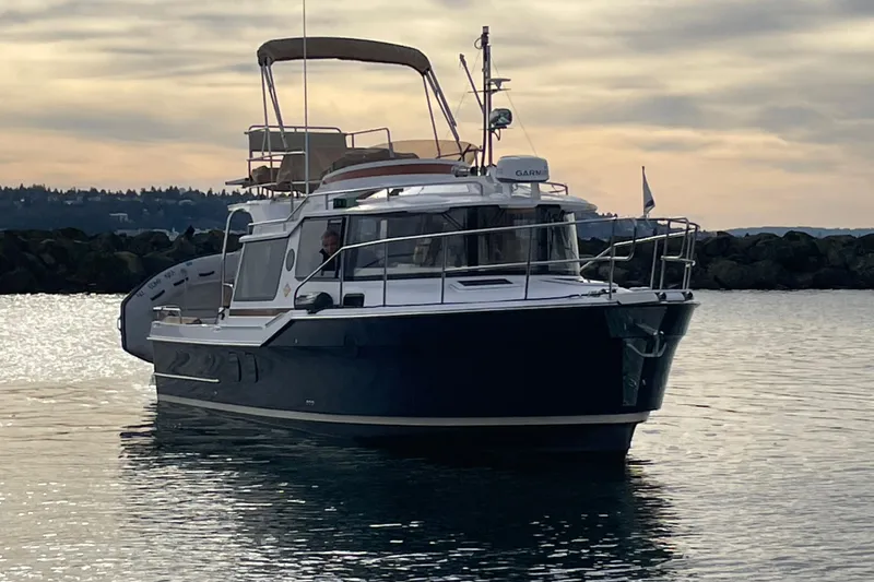 Poseidon&rsquo;s Lanai Yacht Photos Pics 2021 Ranger Tugs R-29 CB cruising on calm waters at sunset.