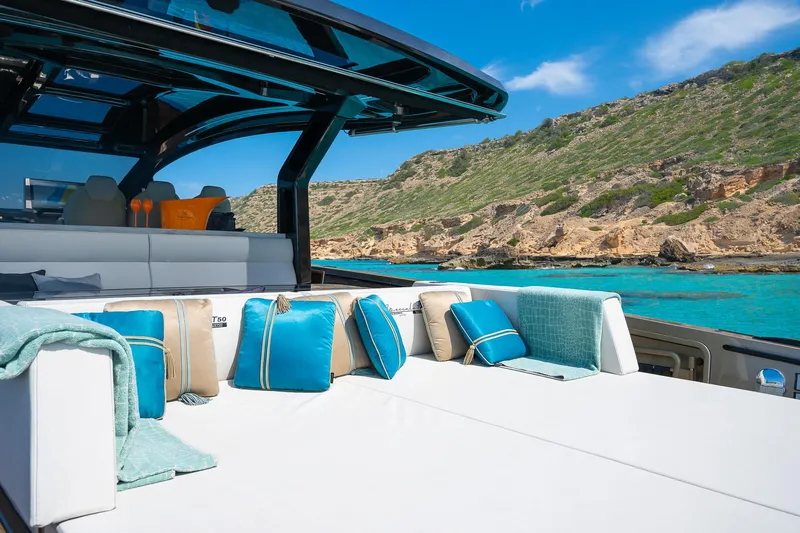  Yacht Photos Pics Luxurious Tesoro GOLDFINGER T50 yacht by Armani, 2025, with elegant seating and scenic coastal view.