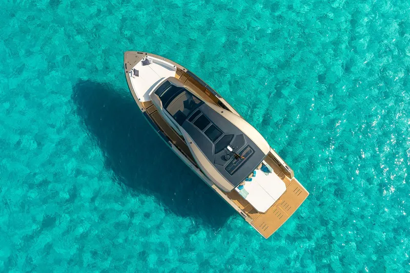  Yacht Photos Pics Luxury Tesoro GOLDFINGER T50 yacht on clear turquoise water, aerial view, 2025 model.