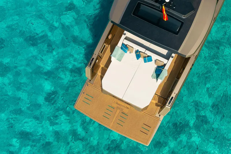  Yacht Photos Pics Luxury Tesoro GOLDFINGER T50 yacht by Armani, 2025, on clear turquoise water.