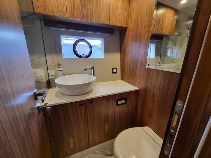 Monachus 70 Fly Yacht Photos Pics Luxurious bathroom in 2026 Monachus 70 Fly yacht with modern fixtures and wood paneling.