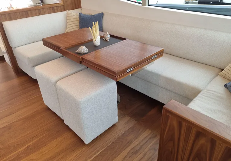 Monachus 70 Fly Yacht Photos Pics Luxurious Monachus 70 Fly 2026 yacht interior with elegant wooden table and plush seating.