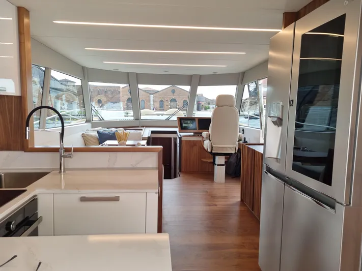 Monachus 70 Fly Yacht Photos Pics Luxurious interior of 2026 Monachus 70 Fly yacht with modern kitchen and helm station.