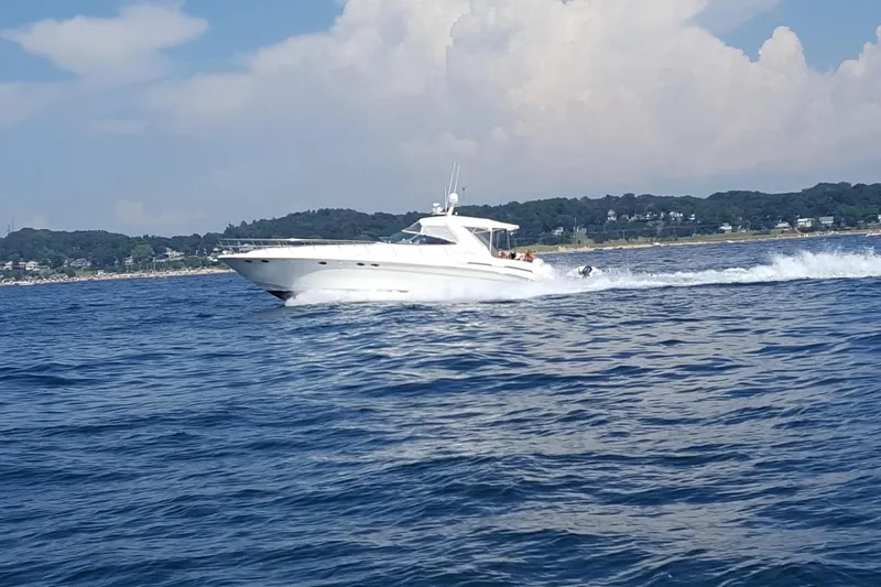  Yacht Photos Pics 1998 Sea Ray 540 Sundancer cruising on open water under a partly cloudy sky.