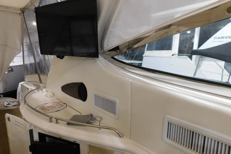  Yacht Photos Pics 1998 Sea Ray 540 Sundancer yacht interior with TV and seating area.