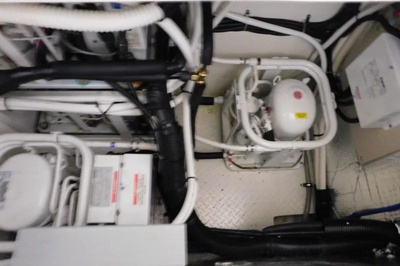  Yacht Photos Pics Engine room of 1998 Sea Ray 540 Sundancer with visible pipes and machinery.