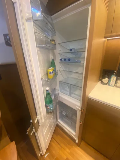  Yacht Photos Pics Open refrigerator inside 2016 Princess V48 Open yacht, stocked with drinks and essentials.