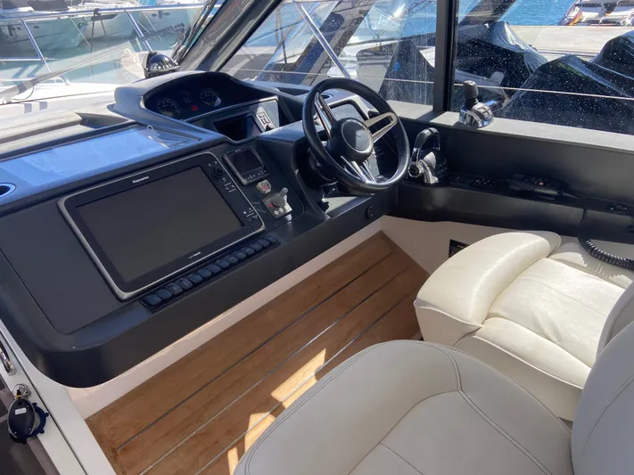  Yacht Photos Pics Helm of 2016 Princess V48 Open yacht with modern controls and leather seating.