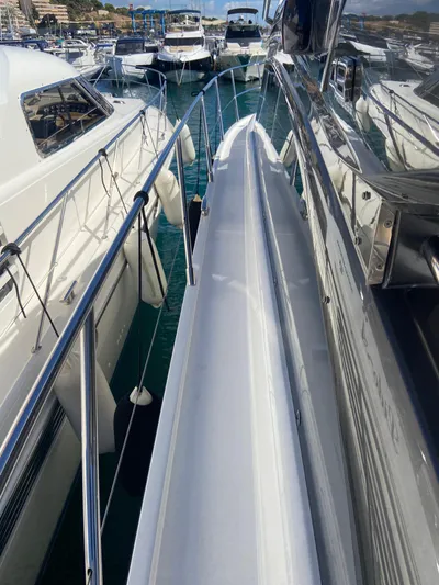  Yacht Photos Pics 2016 Princess V48 Open yacht docked among other boats in a marina.