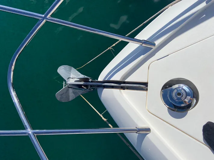  Yacht Photos Pics Anchor and deck of 2016 Princess V48 Open yacht in clear water.