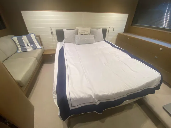  Yacht Photos Pics Luxurious bedroom interior of 2016 Princess V48 Open yacht with elegant bedding and seating.