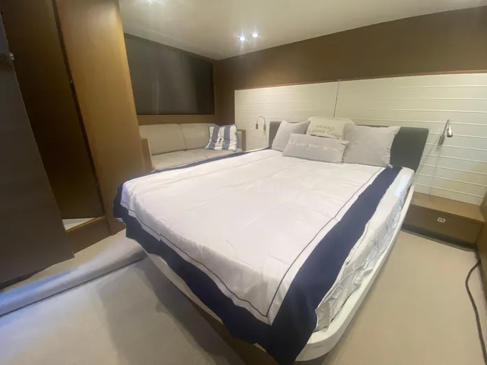  Yacht Photos Pics Luxurious bedroom interior of 2016 Princess V48 Open yacht with elegant bedding and seating.