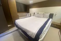 Luxurious bedroom interior of 2016 Princess V48 Open yacht with elegant bedding and seating.