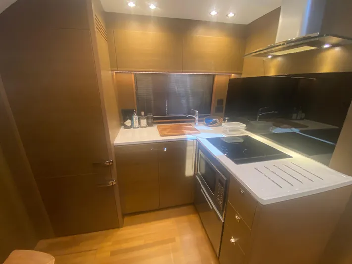  Yacht Photos Pics Luxurious kitchen interior of 2016 Princess V48 Open yacht with modern appliances.