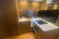 Luxurious kitchen interior of 2016 Princess V48 Open yacht with modern appliances.