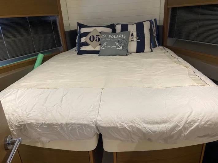  Yacht Photos Pics Cozy bedroom in 2016 Princess V48 Open yacht with nautical-themed pillows.