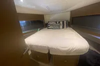 Luxurious bedroom interior of 2016 Princess V48 Open yacht with cozy bedding.