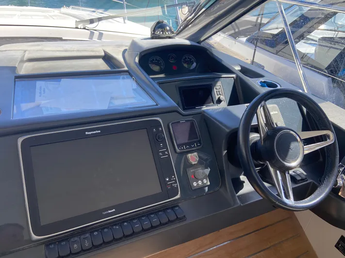  Yacht Photos Pics Helm of 2016 Princess V48 Open yacht with modern navigation controls and steering wheel.