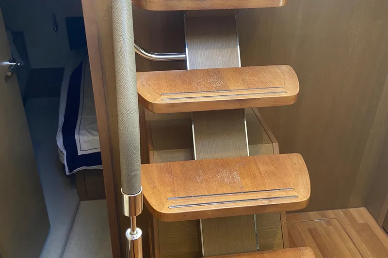  Yacht Photos Pics Wooden staircase inside 2016 Princess V48 Open yacht, leading to cabin area.