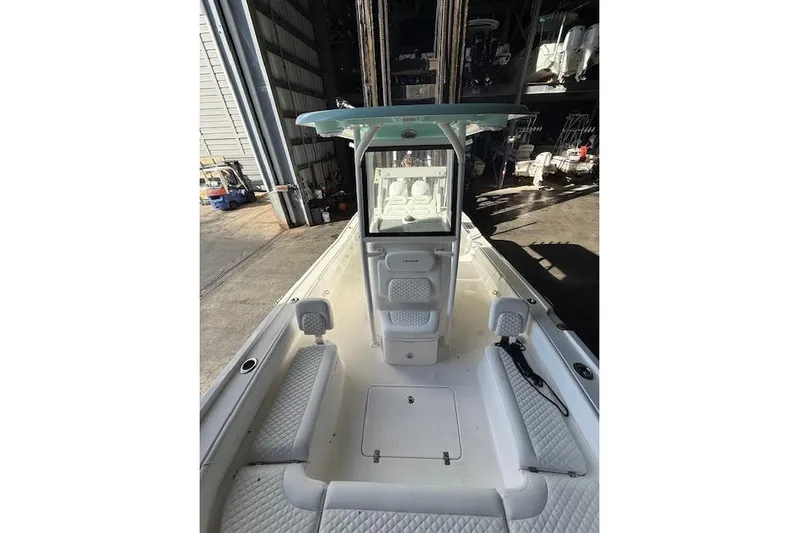  Yacht Photos Pics 2025 Caymas 28 HB boat interior with seating and console in a storage facility.