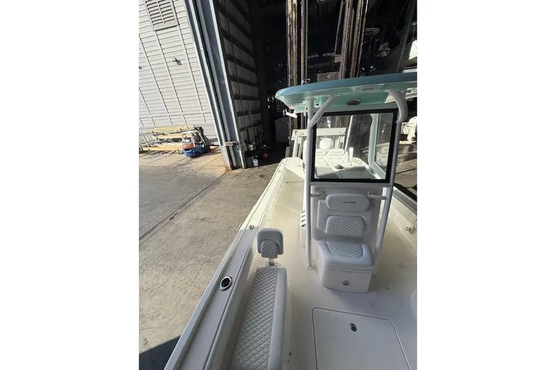  Yacht Photos Pics 2025 Caymas 28 HB boat in a storage facility, showcasing sleek design and seating.